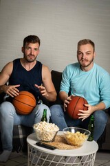 Upset friends frustrated about the loss of the team in game they are watching,