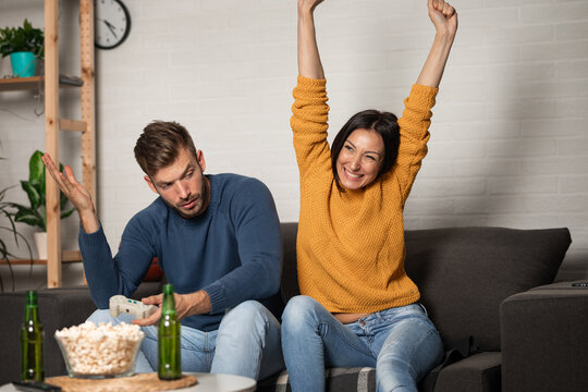 Winner and loser players of couple friend gamers playing video game on TV. - Powered by Adobe