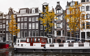 Amsterdam, Netherlands. Panorama of famous dancing houses on river Amstel, water channels with...