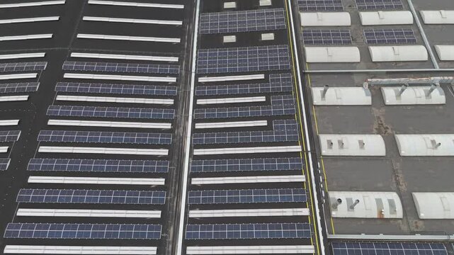 Roof of a modern furniture factory with solar panels from drone. Trnava, Slovakia