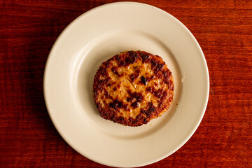 One sausage patty on a plate