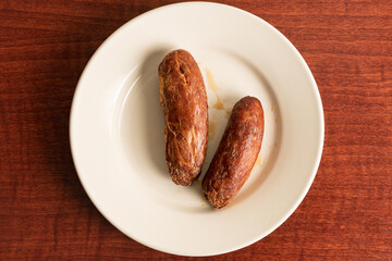 Two sausage links on a plate