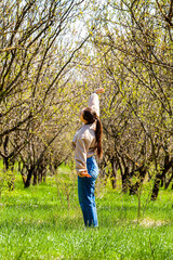 Woman is doing exercising and stretching during dog walking with her border collie outdoors
