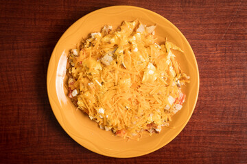 Breakfast garbage plate with eggs, potatoes and cheese