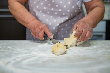 Granny baking buns in the kitchen. High quality photo