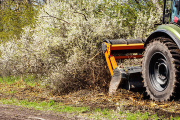 Against a background of nature, a tractor-type machine is captured cutting and clearing forests in...