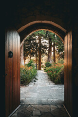 The road less traveled. A darkened arched doorway looks like a fairytale scene, an open door...
