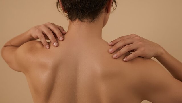 Bare back. Smooth skin. Relaxed pose. Young woman. Natural light. Soft shadows. Nude tones. Wellness concept. Skin care. Spa treatment. Health article. Beauty blog. Massage therapy. Close-up photo. S