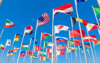 World congress countries national flags waving together on the wind, with American, Japanese, Omani, Chinese, Russian, Iraqi, Egyptian banners in the foreground, Doha, Qatar