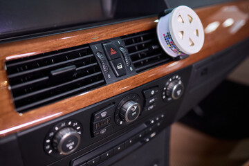 Closeup of car dashboard air vents near gear shift