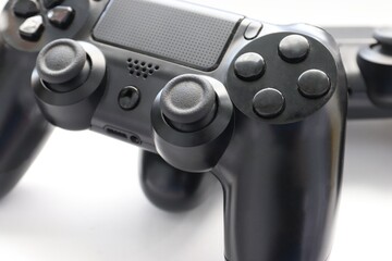 Two game joysticks close up, Modern black game controllers - ergonomic gaming accessories for console, game controllers on white background, joysticks on white background, gamepads © Alla