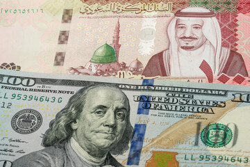 100 Saudi riyal and 100 US dollar banknotes. International trade concept