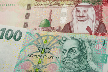 100 Saudi riyal and 100 Czech koruna banknotes. International trade concept