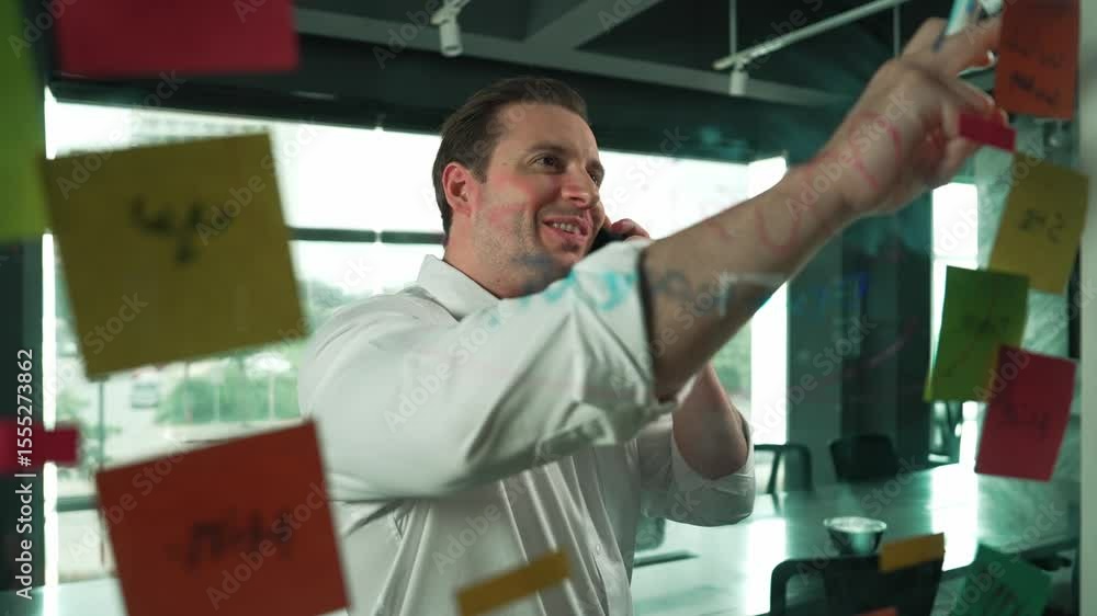 Poster professional businessman making phone call to customers while looking at marketing strategy idea wri