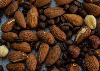 Old spoiled almonds and hazelnuts on top close up