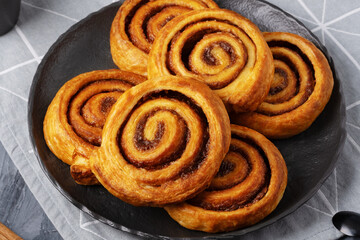 Tasty cinnamon rolls on table, closeup