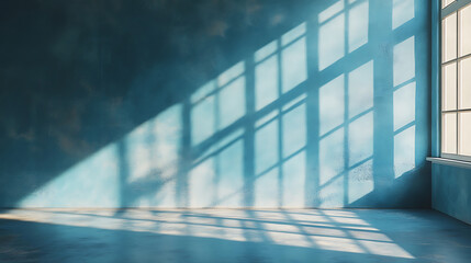 Obraz premium Interior wall with window light and shadows in blue room,creates tranquil atmosphere,suitable for use as a calming backdrop,shows simplicity and minimalism