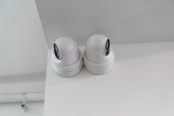 indoor cctv security cameras mounted on ceiling corner, modern surveillance system for building...