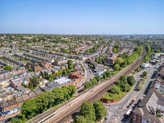 The drone aerial view of Raynes Park. Raynes Park is a residential suburb, railway station and local centre near Wimbledon, London, and is within the London Borough of Merton.