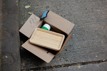 Free items left on sidewalk in urban area showcasing sustainability and community sharing