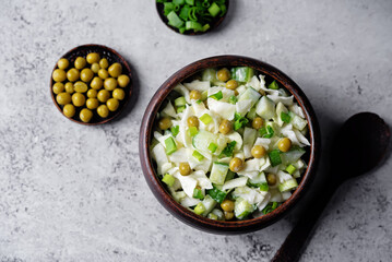Cabbage cucumber green peas mayonnaise salad in a bowl