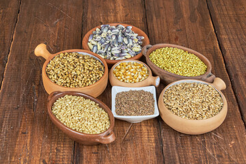 Whole grains concept. A colorful mix of whole grains: wheat, corn, and quinoa. Ingredients for a healthy diet, selective focus.