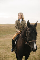 Young Woman Riding a Dark Horse Across an Open Field