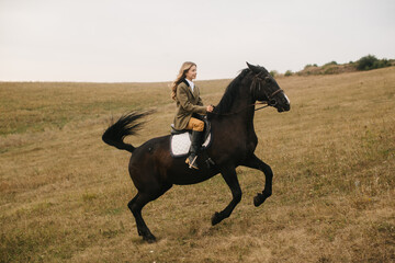 Young Woman Riding a Galloping Horse in a Scenic Countryside Field