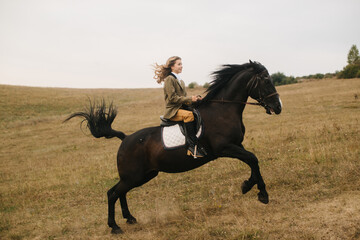 Woman Galloping on a Black Horse in an Open Field