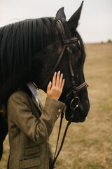 Woman Dressed Elegantly with a Horse in a Countryside Setting