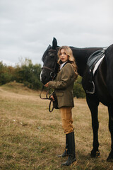 Woman Dressed Elegantly Holding a Horse in a Scenic Country Landscape