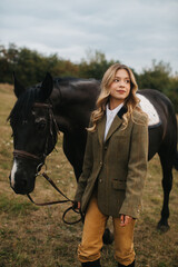 Woman Outdoors with Horse in Equestrian Attire in a Rustic Field