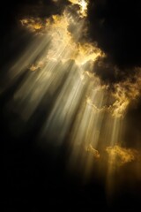 Mystical golden rays of light breaking through dark storm clouds – symbol of divine presence and peace