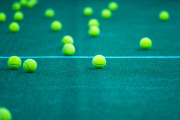 Padel balls on court during sunny day, clean and minimalistic image for sports websites, blogs, and...