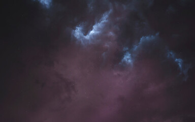 Obraz premium Dark nebula background image with scattered stars. The image features a predominantly dark, smoky aesthetic with subtle variations in tone and texture, evoking a sense of mystery and vastness