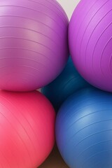 A vibrant collection of fitness balls in various shades of purple, pink, and blue. The textured surface and circular patterns highlight the rubber material