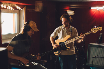 Musicians playing guitars in recording studio