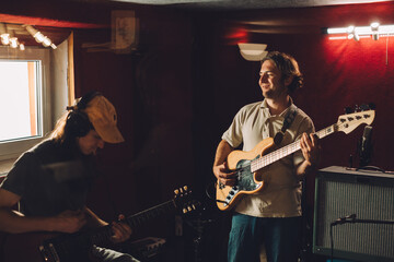 Obraz premium Musicians playing guitars and recording music in studio