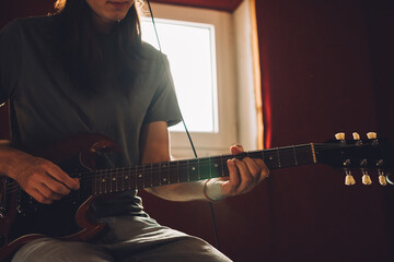 Musician playing electric guitar in recording studio