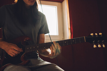 Musician playing electric guitar in recording studio