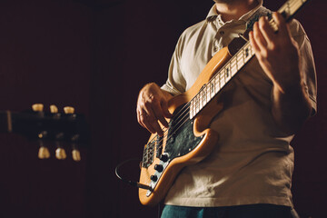 Obraz premium Musician playing bass guitar in recording studio
