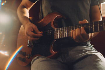 Musician playing electric guitar in recording studio