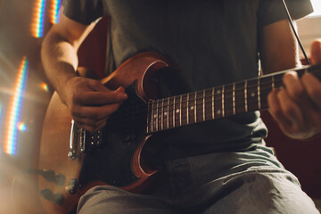 Musician playing electric guitar in recording studio