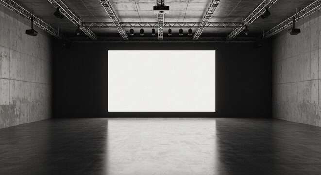 A large blank white screen in a dark room with concrete walls and lighting rig above it all around