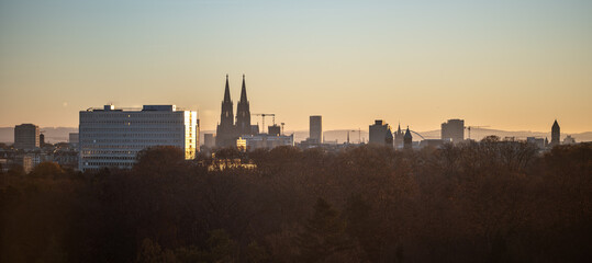 The clear dawn sky provides the backdrop for the dramatic skyline of the urban cityscape of Cologne, which is formed by the cathedral Cologne Dome and other downtown buildings.