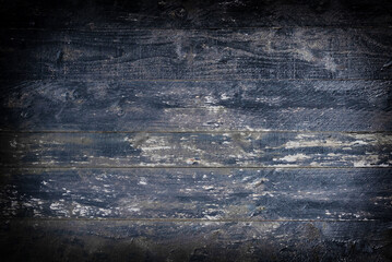 Dark Blue Distressed Wood Texture Background. A rustic and grungy close-up of dark, weathered wooden planks with traces of worn paint, ideal for a textured background.