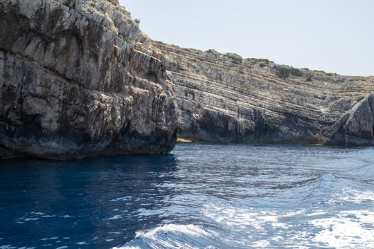 boat trip along rugged limestone cliffs and clear blue waters - Powered by Adobe