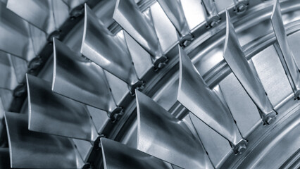 Large metal turbine on table of industrial metalworking programmable CNC machine, industrial machine concept background blue tone © Aleksandr Matveev