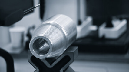 Quality control on milling metal CNC machine, coordinate measuring machine tests a metal detailt, CMM Quality control machine, technology concept blue tone