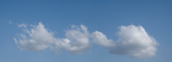 heaven sky is blue with many clouds. clouds are scattered throughout the sky and are of various sizes